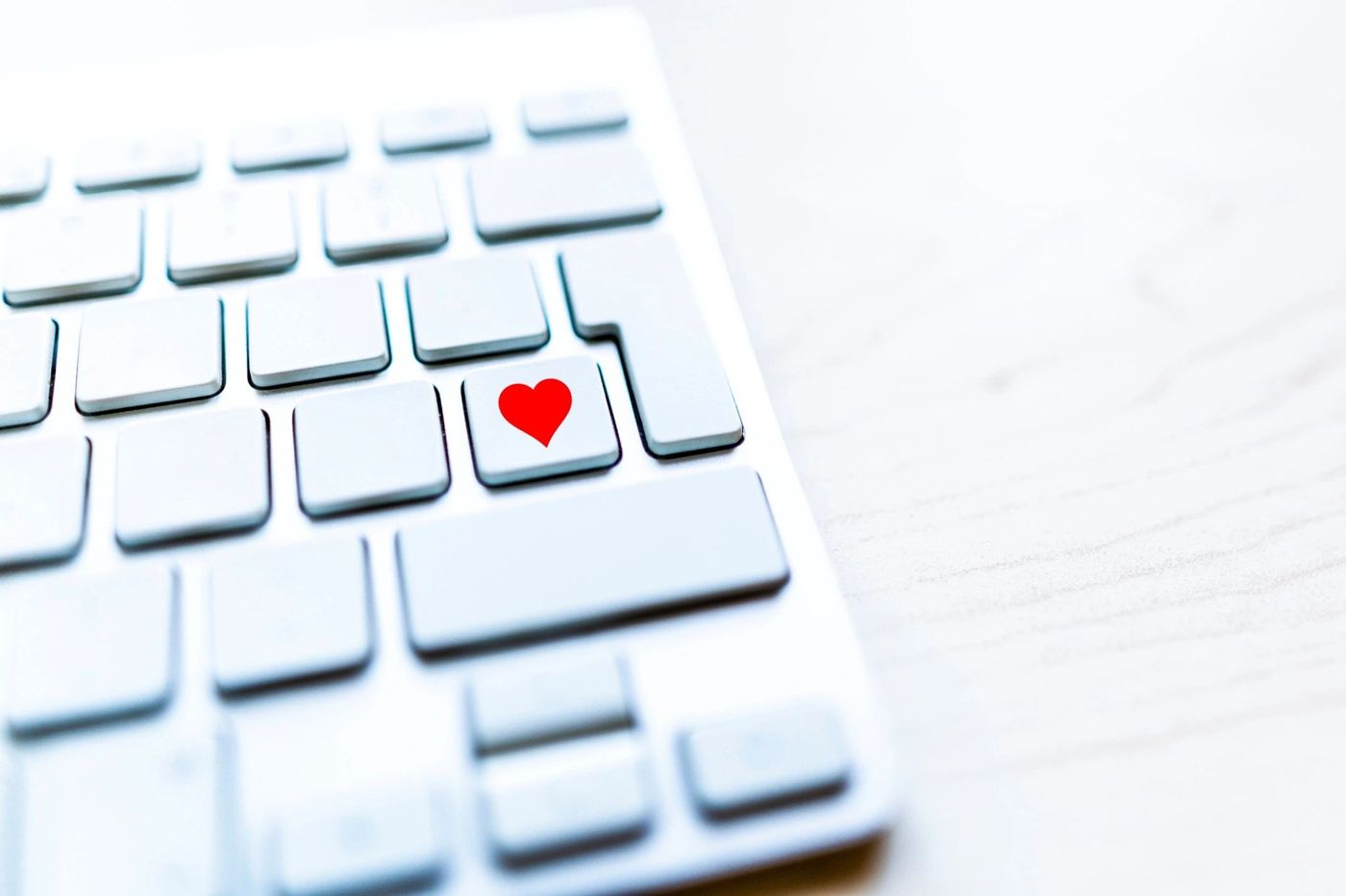 White keyboard with a red heart key