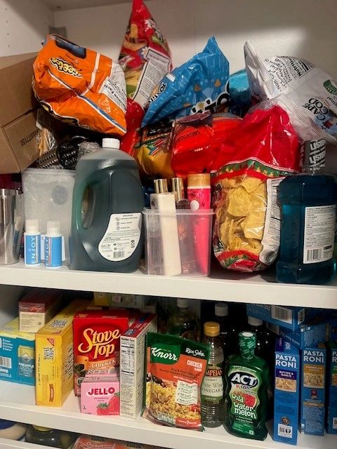 Pantry shelves stocked with food and snacks